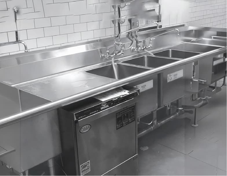 Commercial stainless steel kitchen workspace with stainless steel fixtures
