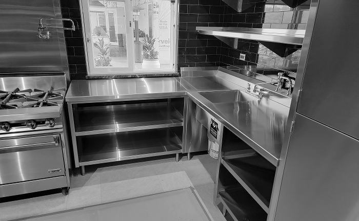 Stainless steel worktables and commercial sinks